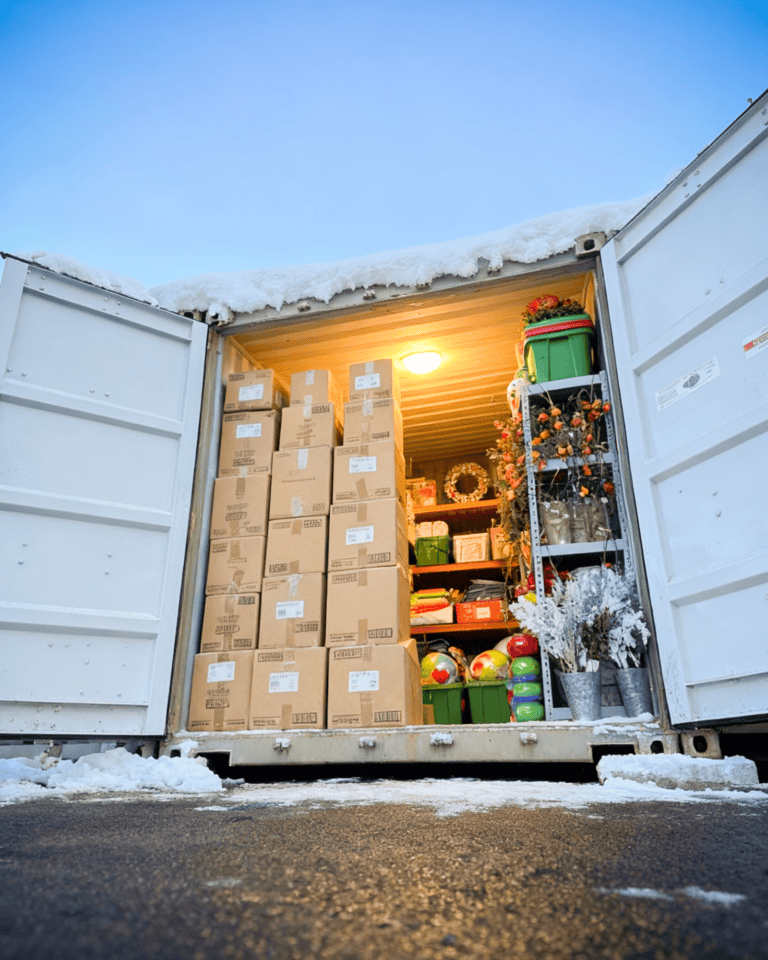 Shelving units packed with business inventory and goods inside a storage container